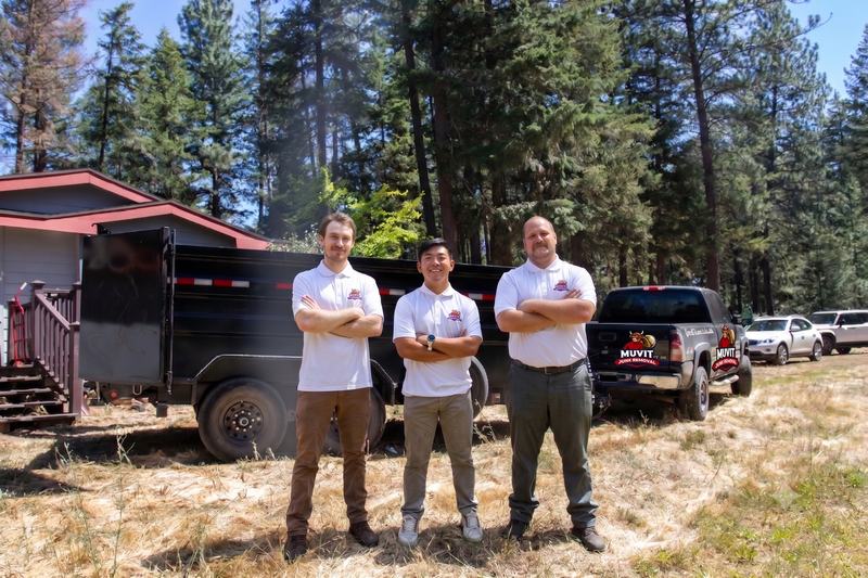The Muvit Junk Removal crew with their branded truck and dump trailer in Spokane County